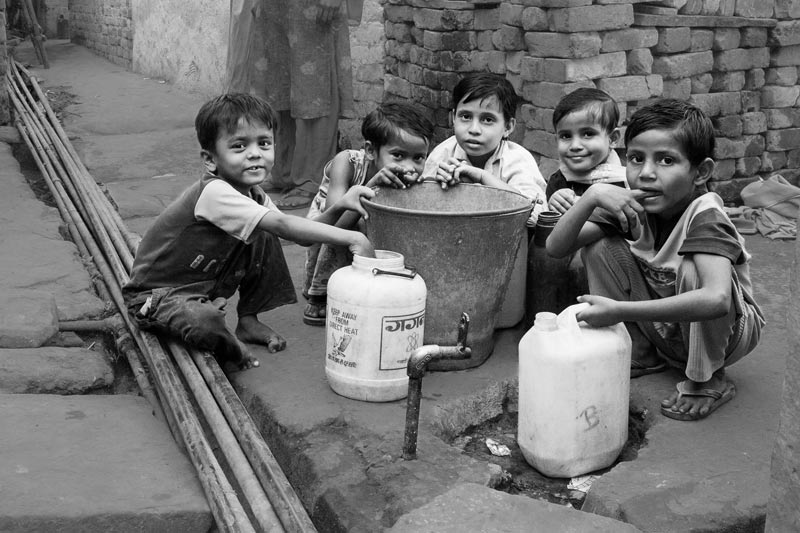 Human Right to Water in Delhi - Waiting for water at a public tapstand in an unauthorized colony in Delhi